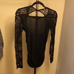 Black open-back lace sleeved top.